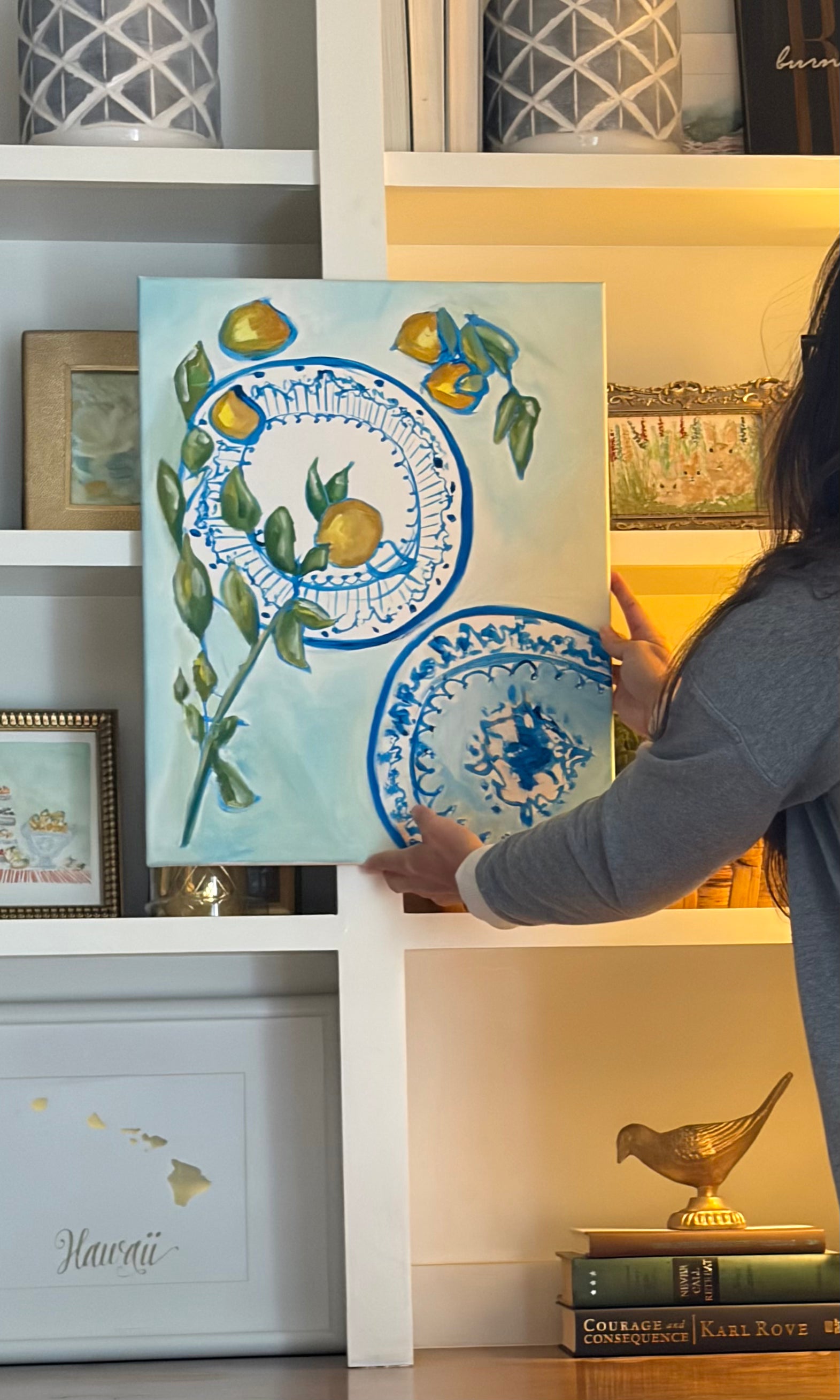 Original lemon and blue porcelain painting displayed in a styled home interior